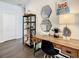 Bright home office with a wooden desk and hexagon mirrors at 547 Marcello Blvd, Kissimmee, FL 34746