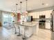 Modern kitchen with stainless steel appliances, white cabinets, and a large island at 547 Marcello Blvd, Kissimmee, FL 34746