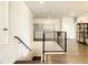 Upstairs hall with modern railing and hardwood floors at 547 Marcello Blvd, Kissimmee, FL 34746