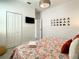 Bedroom with a floral comforter, TV and mirrors on the wall at 547 Marcello Blvd, Kissimmee, FL 34746