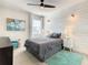 Comfortable bedroom with a ceiling fan, large window, and wood-paneled accent wall at 547 Marcello Blvd, Kissimmee, FL 34746