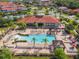 Community pool with plenty of lounge chairs and a clubhouse at 547 Marcello Blvd, Kissimmee, FL 34746