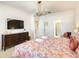 King-size bedroom with a large TV and dresser at 547 Marcello Blvd, Kissimmee, FL 34746