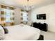 Main bedroom with a king-size bed, a TV, and a sitting area at 547 Marcello Blvd, Kissimmee, FL 34746