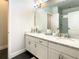 Double vanity bathroom with granite countertops and a walk-in shower at 547 Marcello Blvd, Kissimmee, FL 34746
