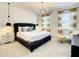 Bedroom with king bed, textured wall and pendant lights at 547 Marcello Blvd, Kissimmee, FL 34746