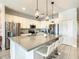 Modern kitchen with stainless steel appliances, white cabinets, and a large island at 547 Marcello Blvd, Kissimmee, FL 34746