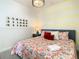 Bedroom with a floral comforter, bedside table, and mirrors at 547 Marcello Blvd, Kissimmee, FL 34746