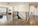 Upstairs hallway featuring hardwood floors and a modern railing at 547 Marcello Blvd, Kissimmee, FL 34746