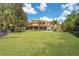 Expansive backyard with lush lawn and mature trees at 5174 Vardon Dr, Windermere, FL 34786