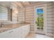 Elegant bathroom with double vanity, granite countertop, and private balcony access at 5174 Vardon Dr, Windermere, FL 34786