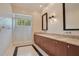 Double vanity bathroom with a shower and patterned wallpaper at 5174 Vardon Dr, Windermere, FL 34786