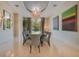 Elegant dining room featuring a large table, chandelier, and modern art at 5174 Vardon Dr, Windermere, FL 34786
