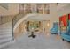 Two-story entryway featuring a curved staircase and marble floors at 5174 Vardon Dr, Windermere, FL 34786