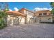 Three-car garage and paver driveway of a large home at 5174 Vardon Dr, Windermere, FL 34786