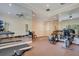 Well-equipped home gym featuring various exercise machines and mirrored walls at 5174 Vardon Dr, Windermere, FL 34786