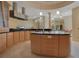 Large kitchen with curved island, stainless steel appliances, and breakfast nook at 5174 Vardon Dr, Windermere, FL 34786