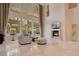 Spacious living room with a fireplace and large windows at 5174 Vardon Dr, Windermere, FL 34786
