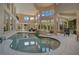 Indoor pool with a spa and open living area at 5174 Vardon Dr, Windermere, FL 34786