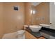 Modern powder room with vessel sink and dark granite countertop at 5174 Vardon Dr, Windermere, FL 34786