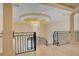 Luxury upper hallway with marble floors and wrought iron railing at 5174 Vardon Dr, Windermere, FL 34786
