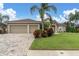 Two-car garage, manicured lawn, and brick pavers at 5528 Pebble Beach Dr, Lakeland, FL 33812