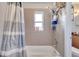 Bathroom with tub, shower, and updated tile at 8116 Powell Dr, Orlando, FL 32822