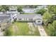 Aerial view of a house with a spacious yard and driveway at 8116 Powell Dr, Orlando, FL 32822