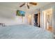 Main bedroom with king bed, ceiling fan, walk-in closet, and bathroom access at 8116 Powell Dr, Orlando, FL 32822