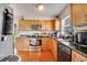 View of kitchen with stainless steel appliances and wood cabinets at 8116 Powell Dr, Orlando, FL 32822