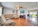 Open living area with sectional sofa, tile floors, and access to the backyard at 8116 Powell Dr, Orlando, FL 32822