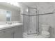 Modern bathroom with grey vanity, marble shower, and white toilet at 5709 Ridgeway Dr, Orlando, FL 32819