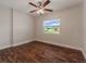Spacious bedroom with dark wood floors and a window overlooking the backyard at 5709 Ridgeway Dr, Orlando, FL 32819