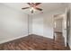 Bright bedroom with dark wood floors, ceiling fan, and double door closet at 5709 Ridgeway Dr, Orlando, FL 32819