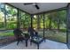 Relaxing screened porch with wicker seating and tranquil garden view at 705 Ashgrove Ter, Sanford, FL 32771