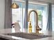 Modern kitchen sink with a gold finish faucet at 918 Savannah Palms Blvd, Orlando, FL 32828