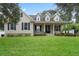 Two-story house with neutral siding and manicured lawn at 70 Millholland St, Oakland, FL 34760