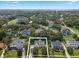 Aerial view of a house nestled in a charming neighborhood near the lake at 70 Millholland St, Oakland, FL 34760