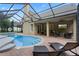 Expansive pool and patio area with ample seating and covered patio at 70 Millholland St, Oakland, FL 34760
