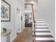 Bright entryway with hardwood floors, staircase, and views to living room at 70 Millholland St, Oakland, FL 34760