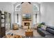 Living room with vaulted ceiling, fireplace and access to pool area at 70 Millholland St, Oakland, FL 34760