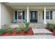 Inviting front porch with teal chairs and a welcoming sign at 70 Millholland St, Oakland, FL 34760
