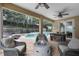 Relaxing pool area with fire pit, covered patio, and comfortable seating at 70 Millholland St, Oakland, FL 34760