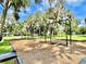 Traditional playground with swings set amongst mature trees at 70 Millholland St, Oakland, FL 34760