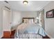 Cozy bedroom featuring a light blue bedding set and hardwood floors at 70 Millholland St, Oakland, FL 34760