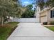 Long driveway with a white fence and a two-car garage at 70 Millholland St, Oakland, FL 34760