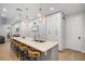 Kitchen island with seating, white cabinets, and stainless steel appliances at 70 Millholland St, Oakland, FL 34760