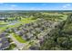 Bird's-eye view of a residential area near a golf course and lake at 130 Golf Vista Cir, Davenport, FL 33837