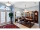 Formal dining room with chandelier, wood table, and china cabinet at 130 Golf Vista Cir, Davenport, FL 33837