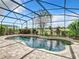 Resort-style pool with fountain and screened enclosure at 8920 Dove Valley Way, Davenport, FL 33896